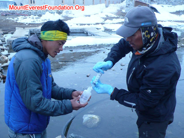Mila Rai and Tenji Sherpa sampling water at the reservoir in Lobuche Village, below Gorak Shep. Photo courtesy MountEverestFoundation.org