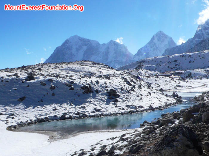Lake at Gorak Shep. This is the current water source as other sources are frozen at the moment. Buildings of Gorak Shep, Tawoche, Cholatse, and Lobuche in the background.