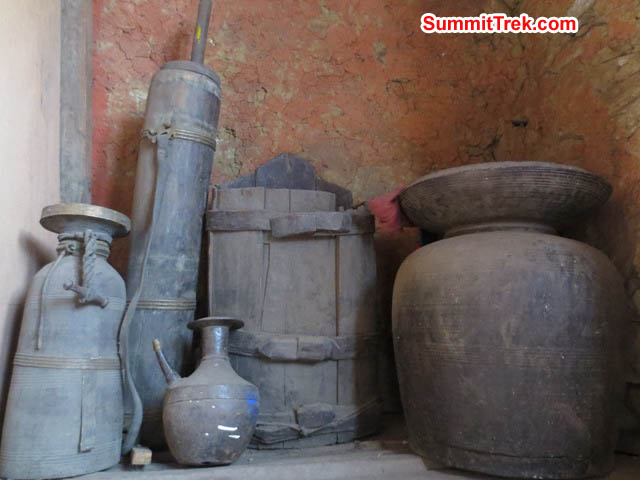 Ancient vessels, butter churns, and chang pots on a shelf inside the Pangboche Monastery. Hannah Rolfson Photo. Ancient vessels, butter churns, and chang pots on a shelf inside the Pangboche Monastery. Hannah Rolfson Photo.