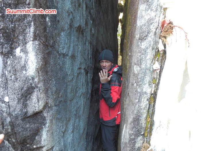 Burkhard Felber between the rock walls at Kote, bringing good luck for her expedition. Photo by Susanne.