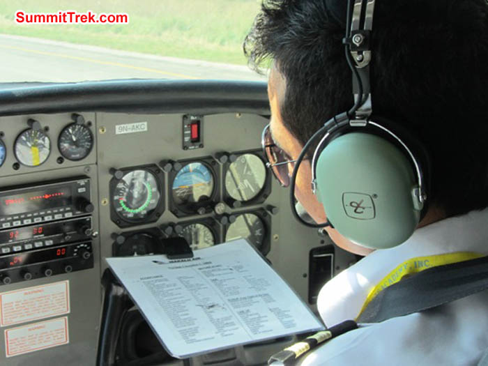 Lukla pilot reviewing his checklist before takeoff at KTM airport. Photo Mark van 't Hof