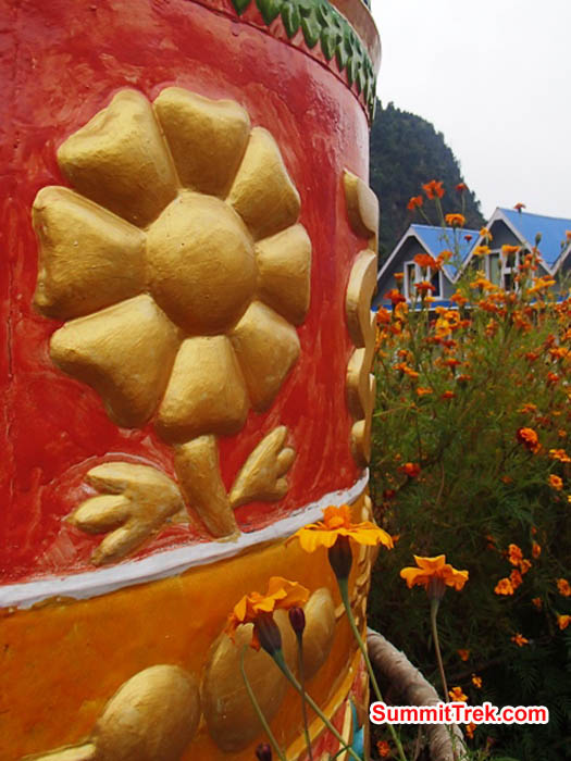 Prayer wheel and a teahouse on the trail to Everest. Maggie Noodle Photo