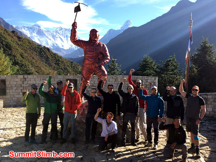 team members with statue