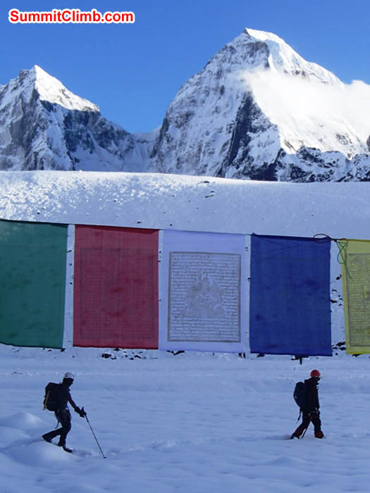Prayer flags and walkers in Ama Dablam basecamp. Maggie Noodle photo