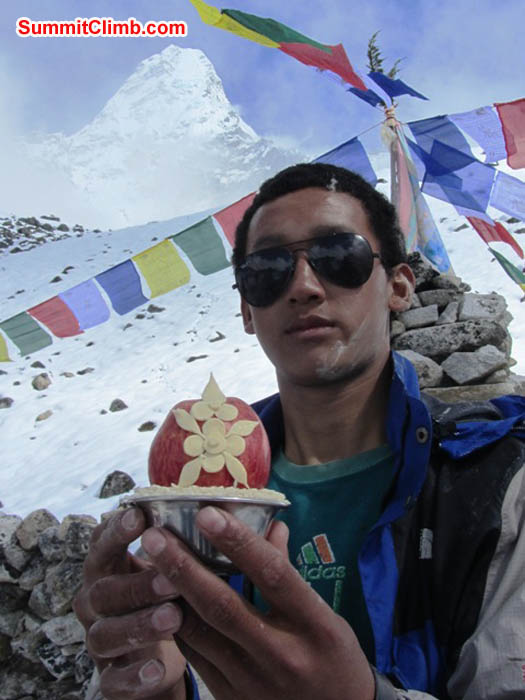 Phurba Sherpa holds a sacred butter and apple offering at the basecamp prayer ceremony. Mark van 't Hof Photo.