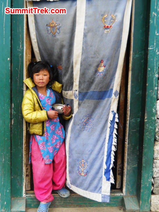Girl standing in a doorway in lukla