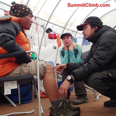 Sange Sherpa, suffering a knee injury from the Khumbu Icefall, being examined by HRA Everest ER basecamp hospital doctors. Monika Witkowska Photo.