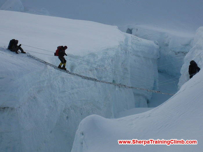 Sherpas helping a member to cross the Khumbu Ice fall. Photo Squash.