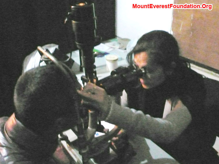 Eye surgeon examining Purba Sherpa