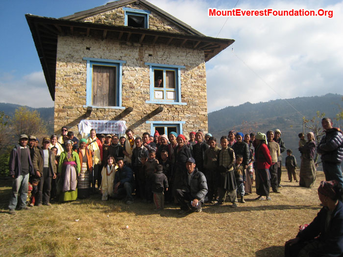 Villagers and service trek members in front of new health post bought by Mount Everest Foundation. Thanks to Mitch Lewsi, Juniper Foundation, Erik Petersen, Equator Adventures and Katherine Peacock, Jonathan Peacock Memorial Fund. Photo by Marie